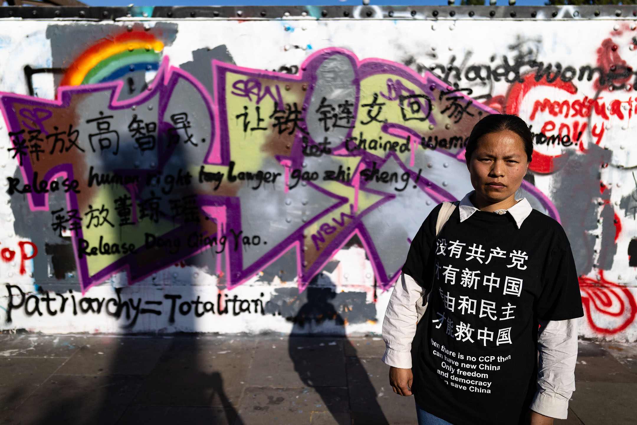 一名女子站在伦敦涂鸦墙前